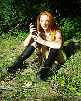 Hot redhead huntress is relaxing in the woods in her green pantyhose